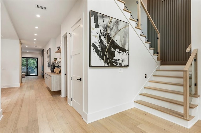 stairs featuring hardwood / wood-style flooring