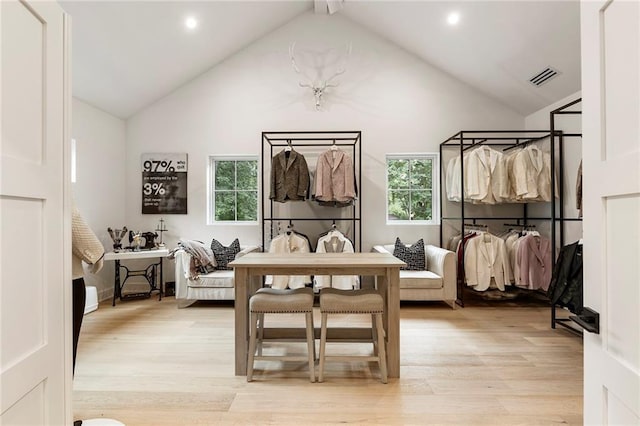 living area featuring vaulted ceiling and light wood-type flooring