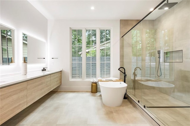 bathroom with independent shower and bath and vanity