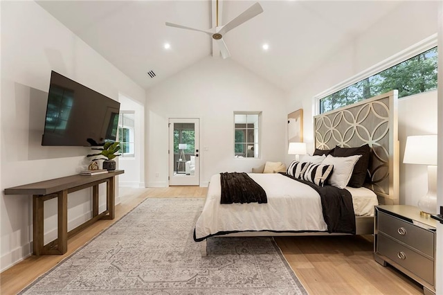 bedroom featuring light wood-type flooring, multiple windows, ceiling fan, and access to outside