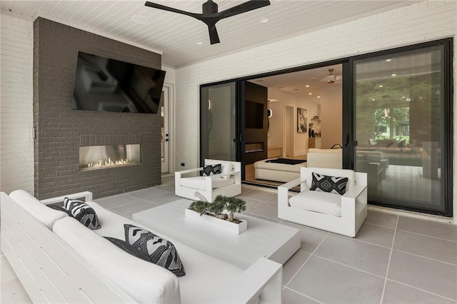 view of patio / terrace featuring an outdoor living space with a fireplace and ceiling fan