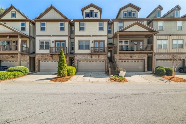 townhome / multi-family property featuring driveway and a garage