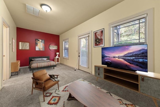 bedroom featuring light colored carpet and multiple windows