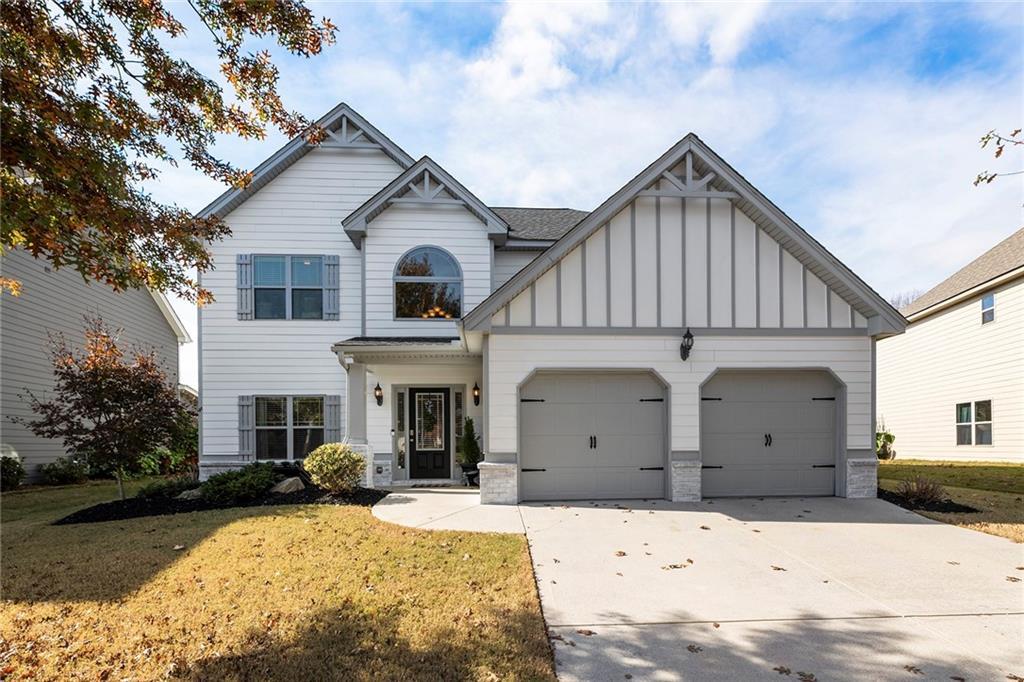 view of front of house with a garage and a front lawn