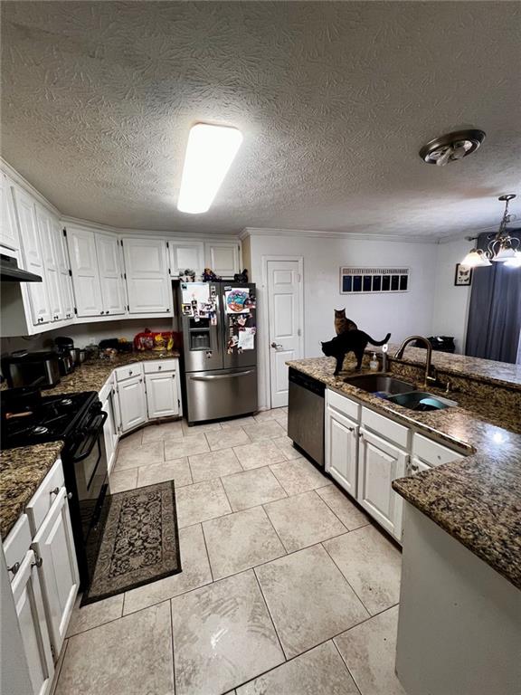 kitchen featuring stainless steel appliances, sink, and white cabinets