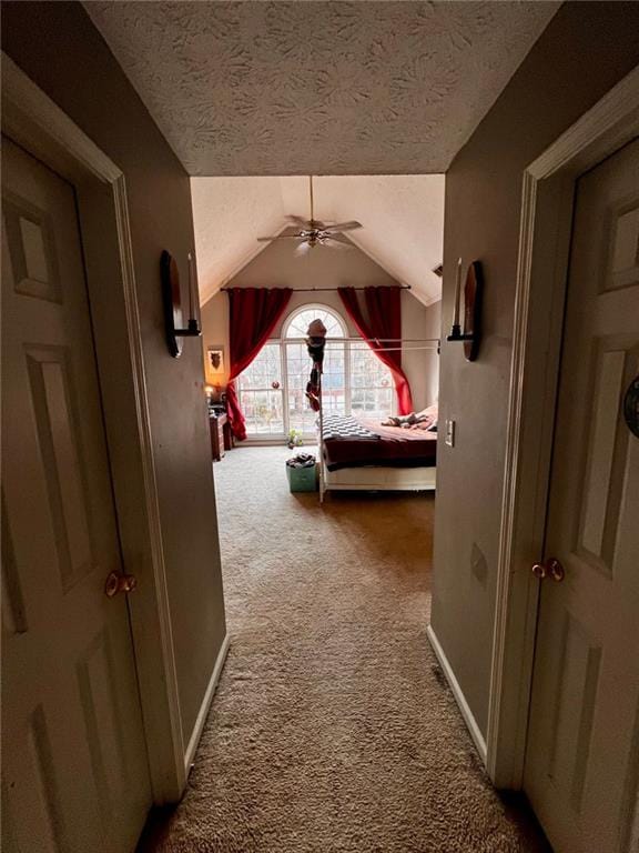 carpeted bedroom with lofted ceiling, ceiling fan, and a textured ceiling