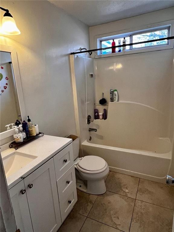 full bathroom with vanity, tile patterned floors, toilet, and washtub / shower combination