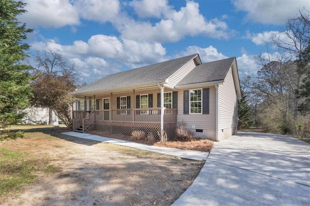 view of front facade featuring covered porch, driveway, a shingled roof, and crawl space