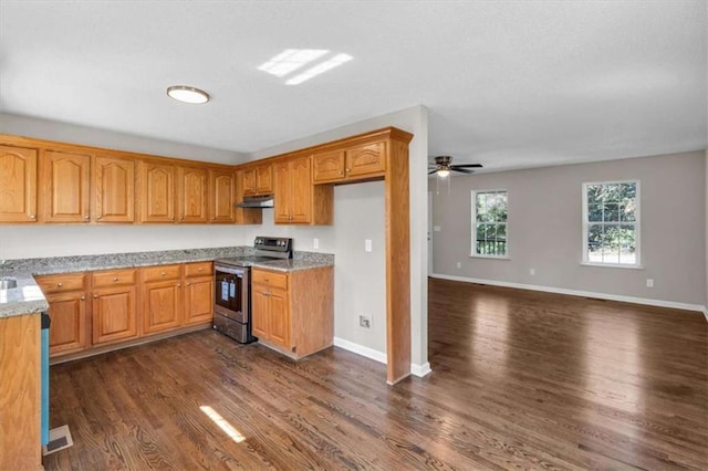 kitchen with dark wood-style floors, brown cabinetry, stainless steel electric range oven, and under cabinet range hood