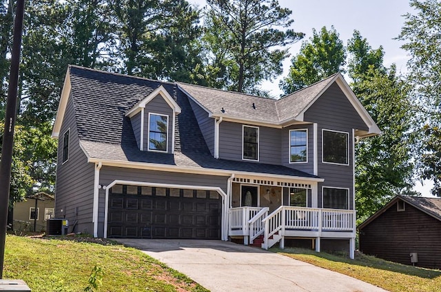 view of front of house featuring a front yard, a garage, and a porch