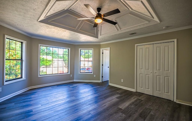 unfurnished bedroom featuring multiple windows, a textured ceiling, dark hardwood / wood-style flooring, and ceiling fan