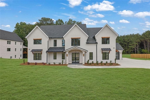 3893 Indian Shoals Rd, Dacula, GA 30019 - view of front of property with a standing seam roof, driveway, a front lawn, french doors, and a metal roof