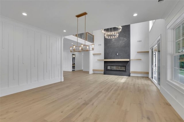 3893 Indian Shoals Rd, Dacula, GA 30019 - unfurnished living room with a chandelier, light wood-type flooring, recessed lighting, and a fireplace