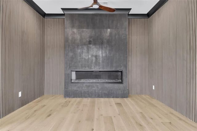 3893 Indian Shoals Rd, Dacula, GA 30019 - unfurnished living room with a large fireplace, ceiling fan, and wood finished floors