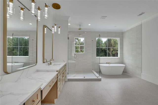 3893 Indian Shoals Rd, Dacula, GA 30019 - bathroom featuring vanity, a stall shower, a freestanding tub, crown molding, and tile patterned floors