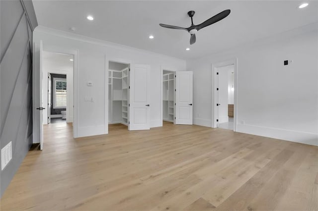 3893 Indian Shoals Rd, Dacula, GA 30019 - unfurnished bedroom with a walk in closet, light wood-style flooring, crown molding, recessed lighting, and ensuite bath