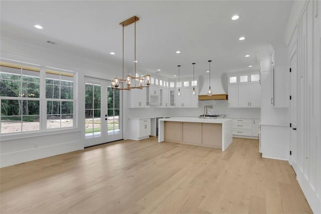 3893 Indian Shoals Rd, Dacula, GA 30019 - kitchen with a kitchen island, light wood-type flooring, recessed lighting, and white cabinetry