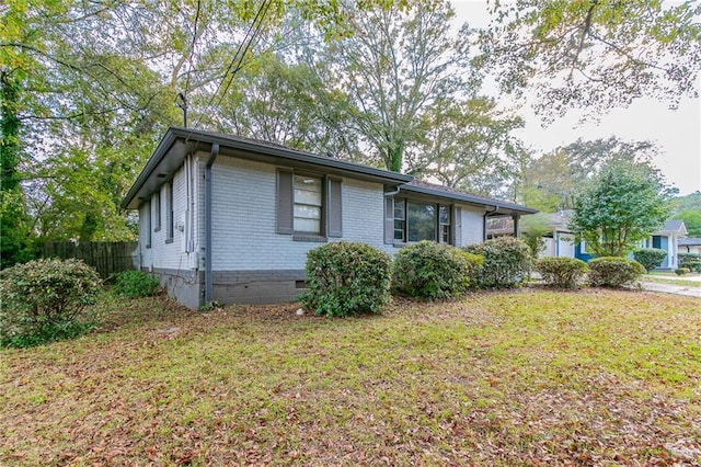 view of side of home with a lawn