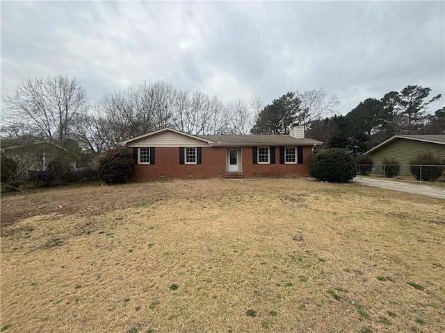 ranch-style home with a chimney, crawl space, fence, a front lawn, and brick siding