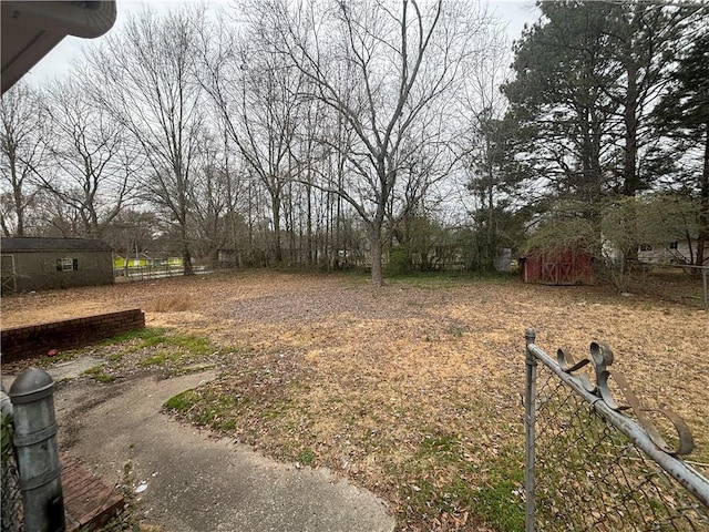 view of yard with fence and an outdoor structure