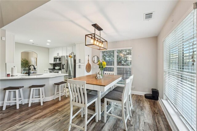 45 Peregrine Ln S, Dawsonville, GA 30534 - dining space with recessed lighting, visible vents, dark wood-type flooring, arched walkways, and baseboards