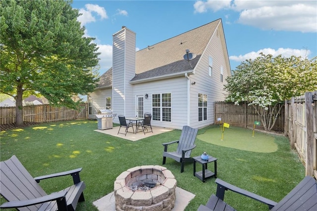 45 Peregrine Ln S, Dawsonville, GA 30534 - back of property with a patio area, a fenced backyard, a fire pit, and a yard