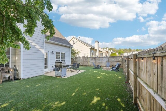 45 Peregrine Ln S, Dawsonville, GA 30534 - view of yard featuring a fenced backyard, a fire pit, and a patio