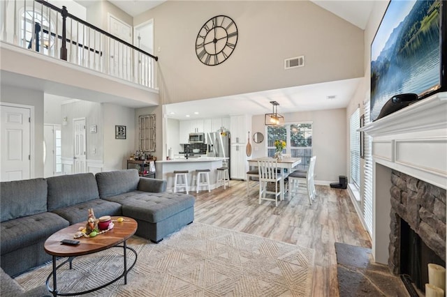 45 Peregrine Ln S, Dawsonville, GA 30534 - living room featuring a fireplace, visible vents, light wood finished floors, and high vaulted ceiling