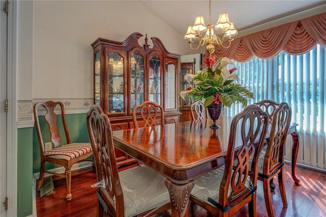 dining room with a chandelier, healthy amount of natural light, and wood finished floors