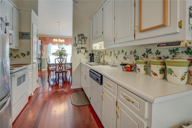 kitchen featuring a sink, white appliances, a chandelier, dark wood-style floors, and light countertops