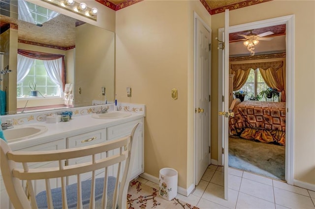 full bathroom with connected bathroom, double vanity, baseboards, a ceiling fan, and tile patterned flooring