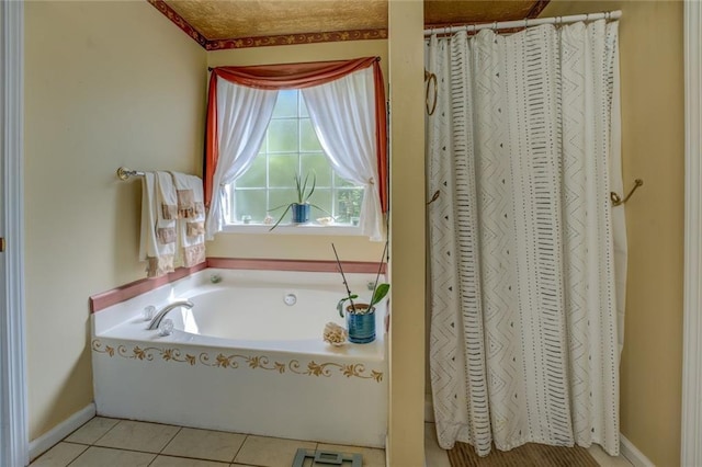 bathroom with a bath, tile patterned floors, and baseboards