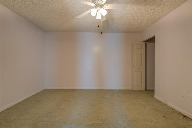 unfurnished room with a textured ceiling, light colored carpet, a ceiling fan, and baseboards