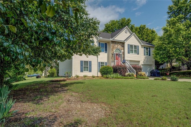 bi-level home featuring a garage and a front lawn