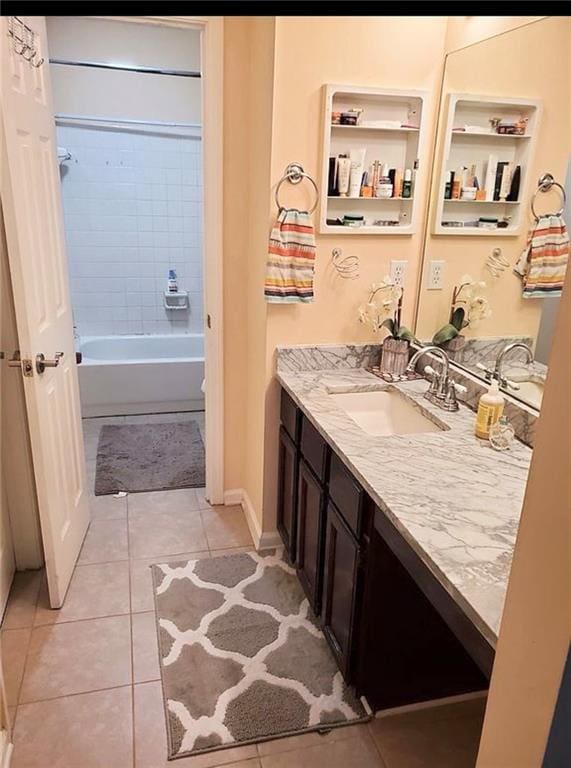 bathroom featuring vanity, tile patterned floors, and tiled shower / bath combo