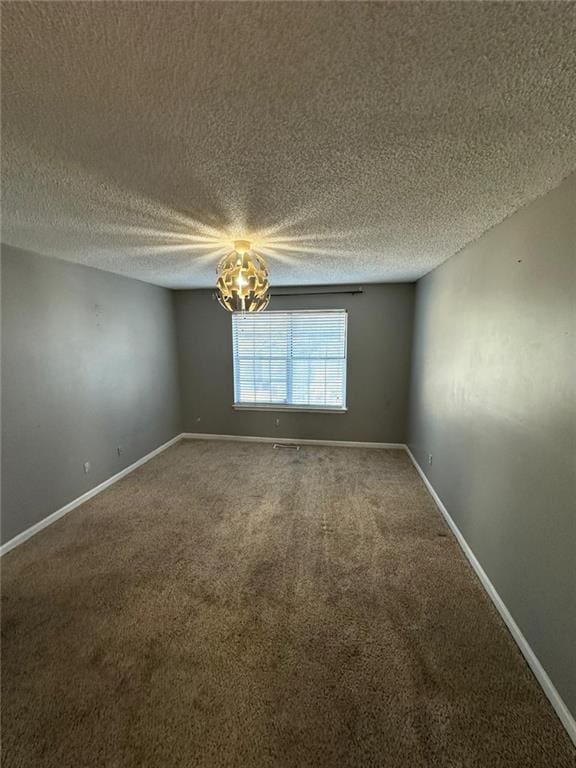 unfurnished room featuring a textured ceiling and carpet floors