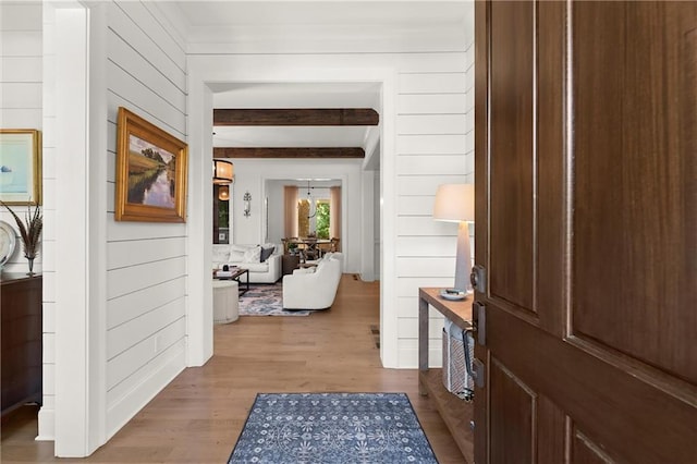 hall featuring wood finished floors and wooden walls