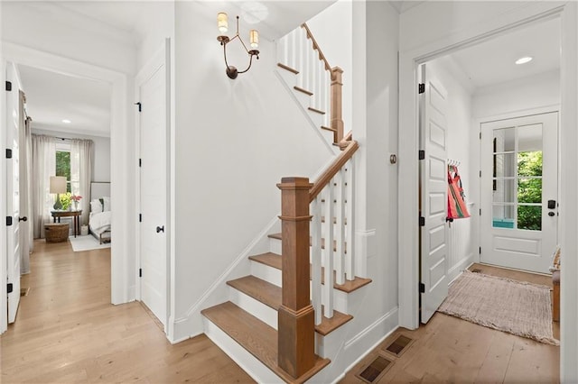 entryway featuring light wood-type flooring, stairway, baseboards, and recessed lighting