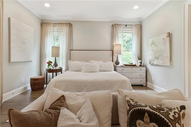 bedroom featuring baseboards, wood finished floors, crown molding, and recessed lighting