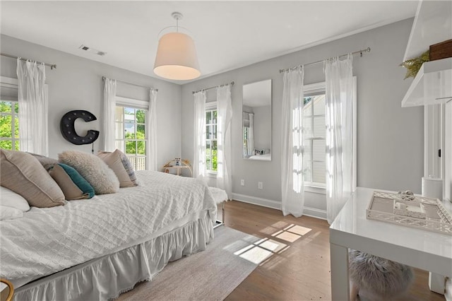 bedroom with wood finished floors and baseboards