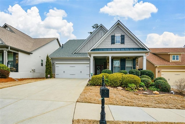 view of front of property with board and batten siding, driveway, and an attached garage