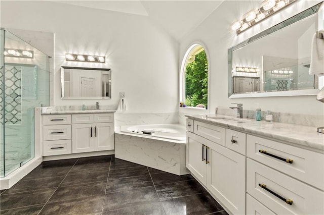 2055 Beacon Hill Way, Alpharetta, GA 30005 - full bathroom with vaulted ceiling, two vanities, a garden tub, and a marble finish shower