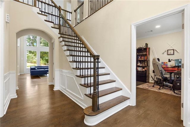 2055 Beacon Hill Way, Alpharetta, GA 30005 - stairway with arched walkways, wood finished floors, wainscoting, ornamental molding, and a towering ceiling