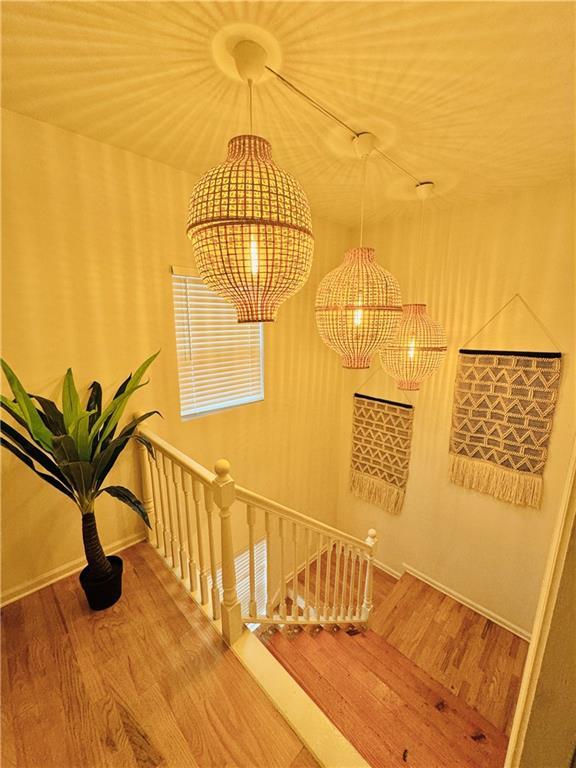 hallway with hardwood / wood-style flooring