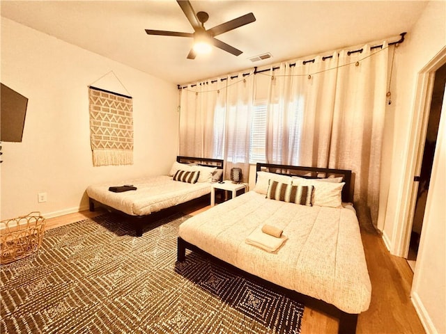 bedroom featuring wood-type flooring and ceiling fan