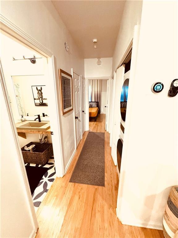 hallway featuring sink and light wood-type flooring