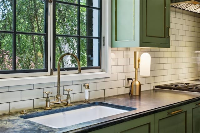3086 E Pine Valley Rd NW, Atlanta, GA 30305 - kitchen featuring green cabinetry, backsplash, dark countertops, and a sink