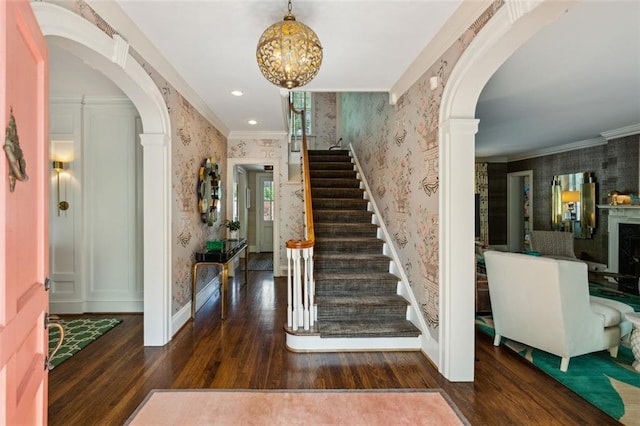 3086 E Pine Valley Rd NW, Atlanta, GA 30305 - entryway with wood finished floors, stairway, crown molding, arched walkways, and wallpapered walls