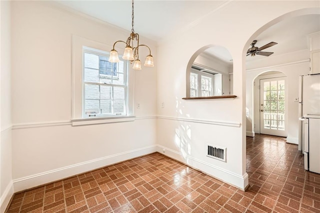 spare room featuring baseboards, visible vents, and ornamental molding