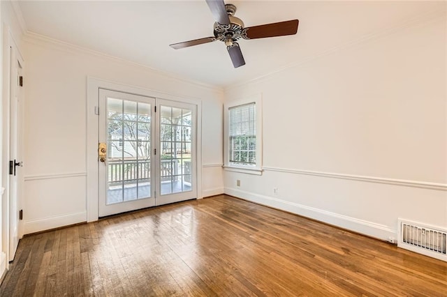 unfurnished room featuring visible vents, a ceiling fan, hardwood / wood-style flooring, crown molding, and baseboards